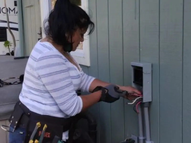 Licensed electrician wiring an exterior subpanel in Stone Park